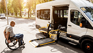 man in wheelchair getting into vehicle