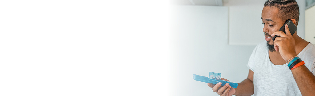 man looking at pill container