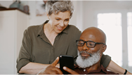 Woman and man looking at cell phone together Woman and man looking at cell phone together