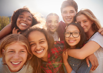 group of children embracing and smiling