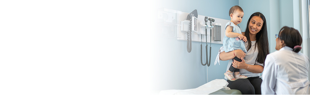 mother with child talking to doctor