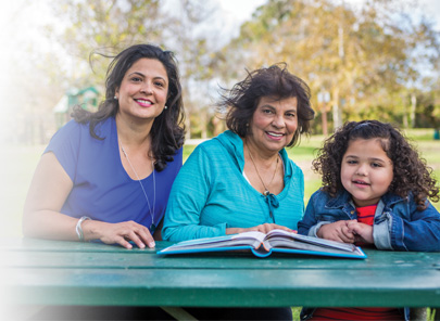 Grandmother Mother Daughter sitting in a table