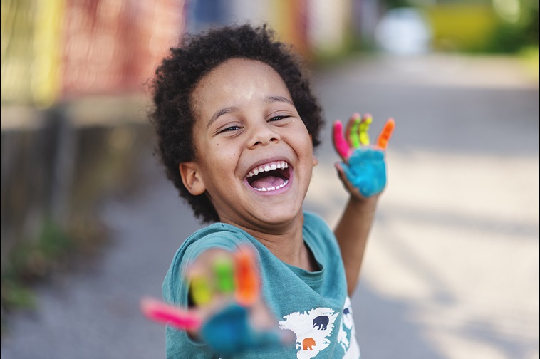 smiling boy with chalk on his hands
