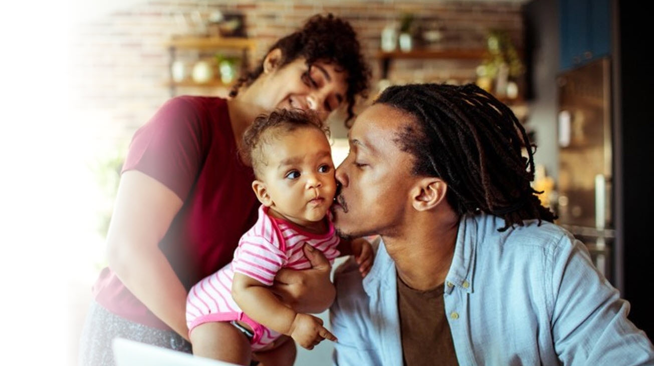 father kissing baby
