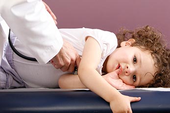 Doctor checking childs heartbeat